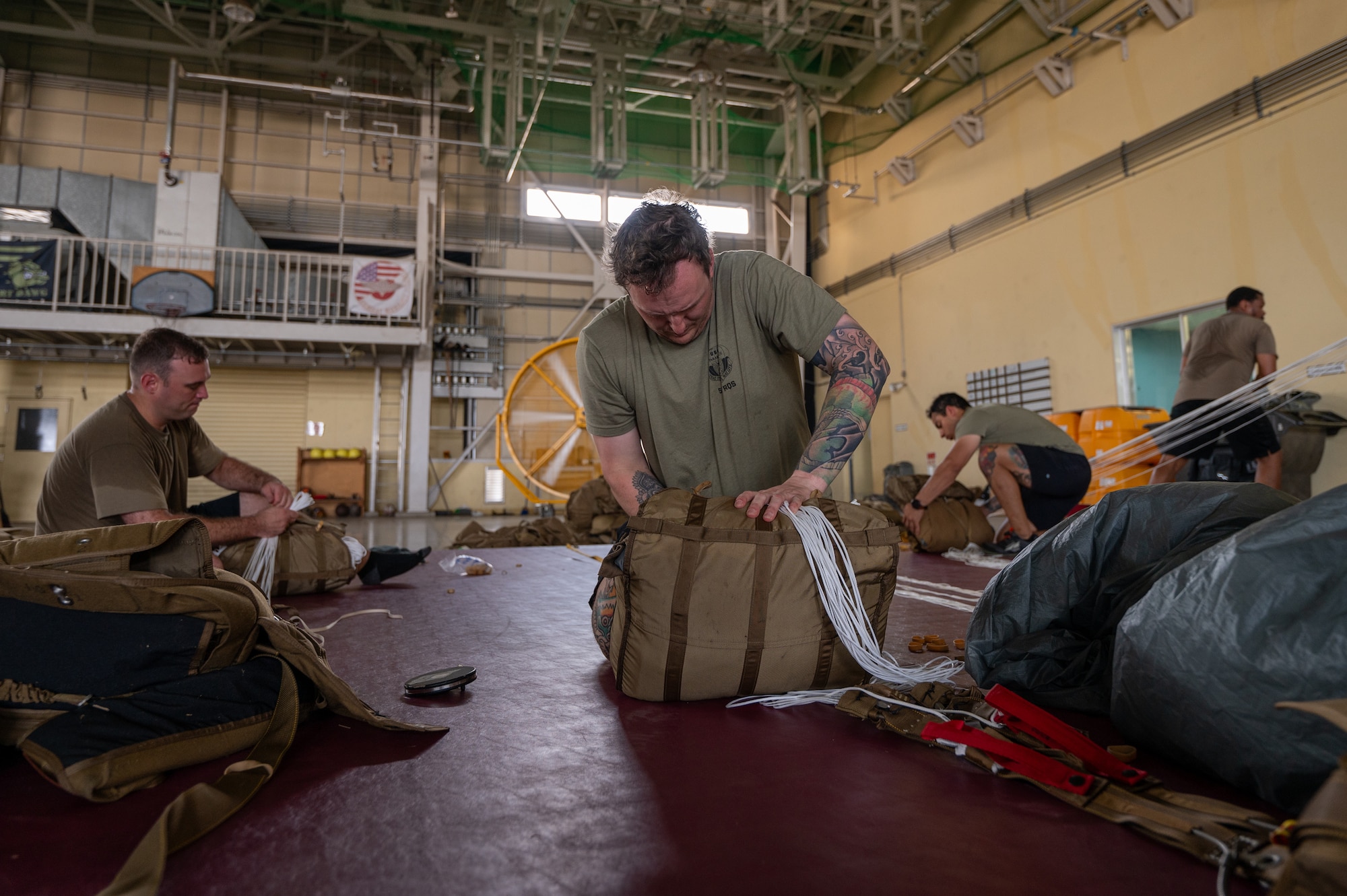 Service member puts together a parachute
