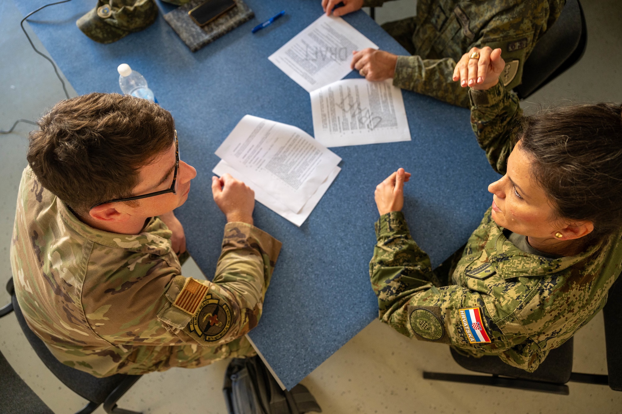U.S. Air Force Maj. Scott Suter, 86th Aeromedical Evacuation Squadron director of operations, discusses Role 2 organization with Croatian army Maj. Milijana Danilovic, a medical doctor, during the development of the Role 2 standard operating procedure at the Military Medical Center in Zagreb