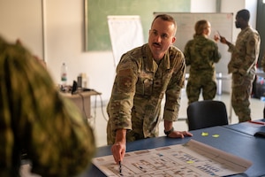 U.S. Air Force Maj. Kolby Parent, The United States Air Forces in Europe - Air Forces Africa Office of the Command Surgeon international health specialist, speaks with Croatian army medical personnel during a global health engagement at the Military Medical Center in Zagreb