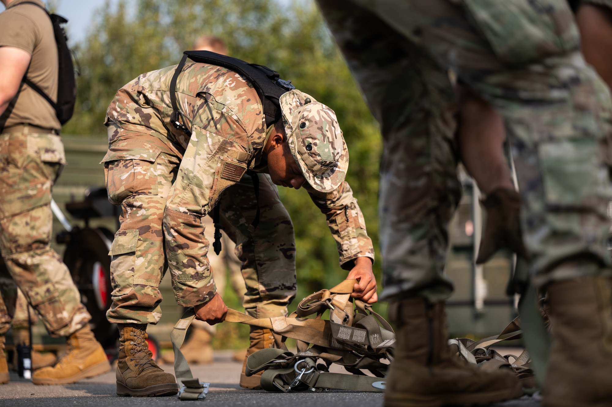 U.S. Air Force Airman Rafael Martinez Capellan, precision guided munitions crew chief assigned to the 86th Munitions Squadron, tightens straps to an aircraft pallet during an exercise at Ramstein Air Base