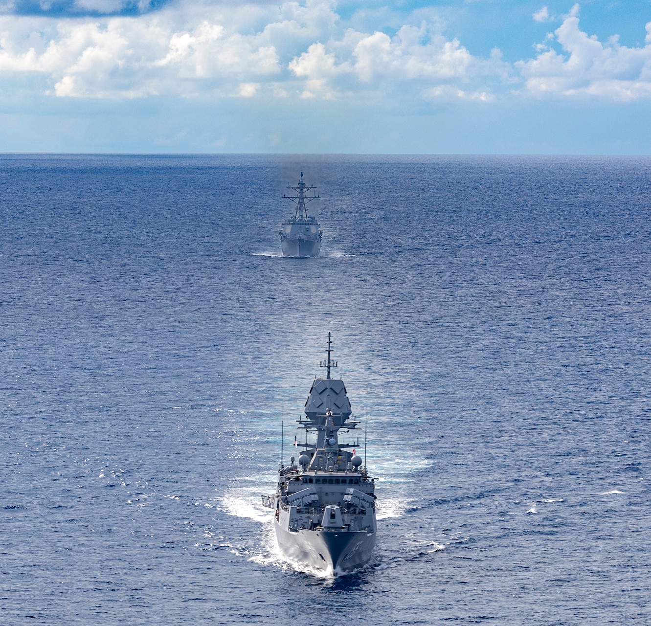 Arleigh Burke-class guided-missile destroyer USS Dewey (DDG 105), back, sails alongside Anzac-class frigate HMAS Ballarat (FFH 155), front, during a bilateral training with the Royal Australian Navy in the South China Sea, Sept. 16, 2025.