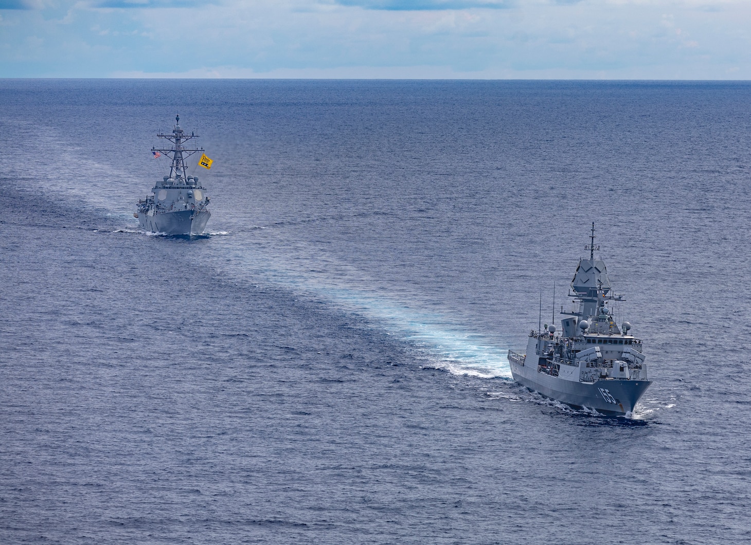 Arleigh Burke-class guided-missile destroyer USS Dewey (DDG 105), left, sails alongside Anzac-class frigate HMAS Ballarat (FFH 155), right, during a bilateral training with the Royal Australian Navy in the South China Sea, Sept. 16, 2025.