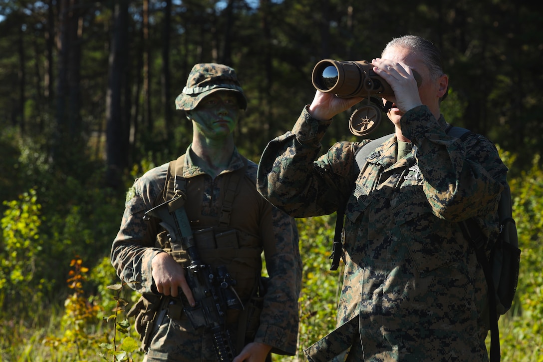 U.S. Marine Corps Pfc. Teigen Dowd, a rifleman with Alpha Company, 2d Light Armored Reconnaissance Battalion, 2d Marine Division, and U.S. Navy Command Master Chief April Merriman, with 2d Marine Division, discuss the Scout Sniper Observation Tool (SSOT) at Korso, Sweden, Sept. 3, 2025. The exercise strengthens the relationship between the United States and Sweden while providing a unique training opportunity to further enhance the readiness and capabilities of the Marines and their Swedish counterparts. (U.S. Marine Corps photo by Cpl. Xavier Alicea)