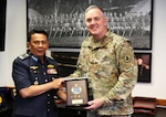 Maj. Gen. Gent Welsh, the adjutant general of the Washington National Guard, and Lt. Gen. Nur Hafis bin Abdul Karim, deputy chief of the Royal Malaysian Air Force, exchange gifts during an office visit Sept. 12, 2025, at Camp Murray, Wash. The Washington National Guard and Malaysia have been partners through the National Guard State Partnership Program since August 2017.