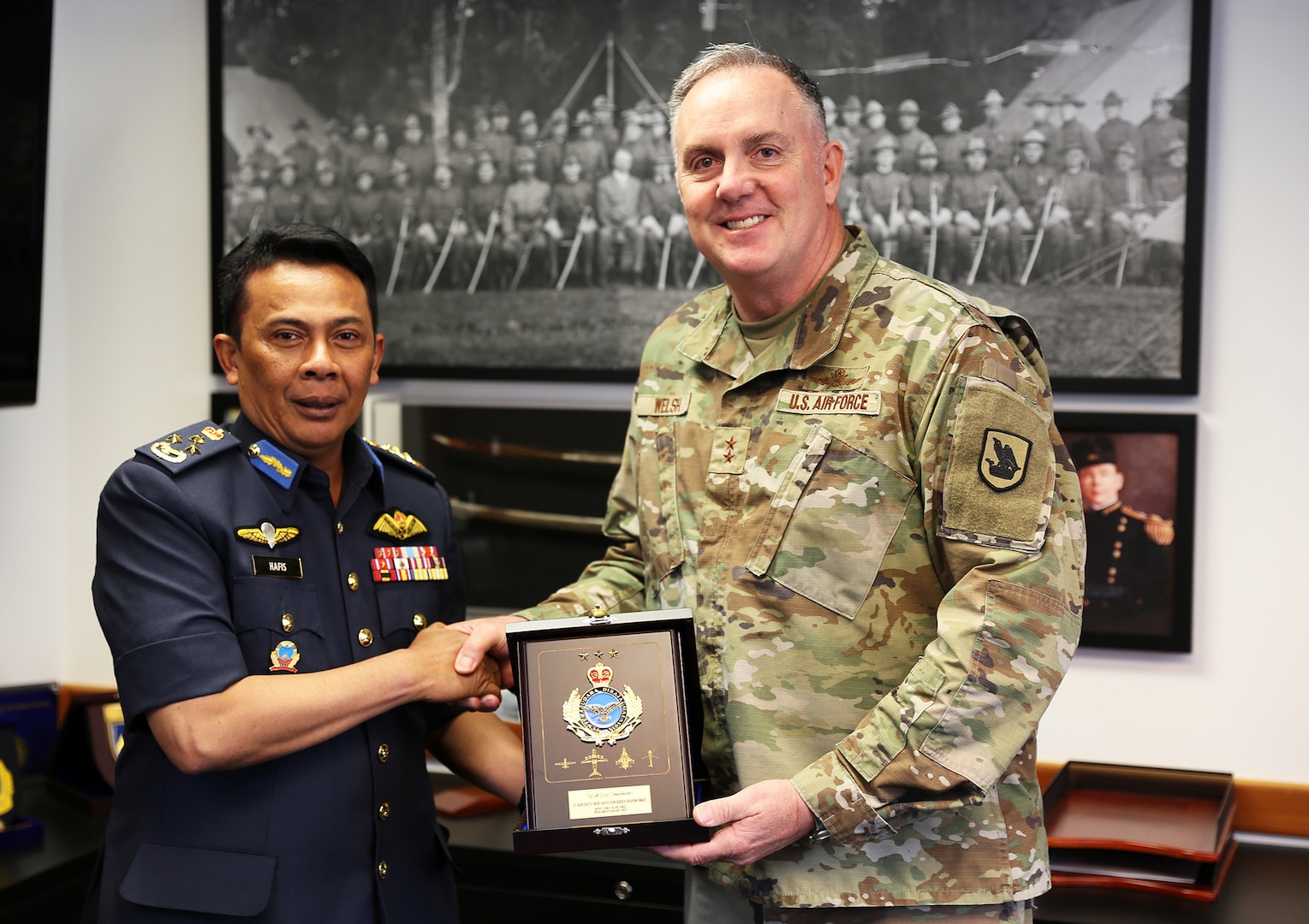 Maj. Gen. Gent Welsh, the adjutant general of the Washington National Guard, and Lt. Gen. Nur Hafis bin Abdul Karim, deputy chief of the Royal Malaysian Air Force, exchange gifts during an office visit Sept. 12, 2025, at Camp Murray, Wash.