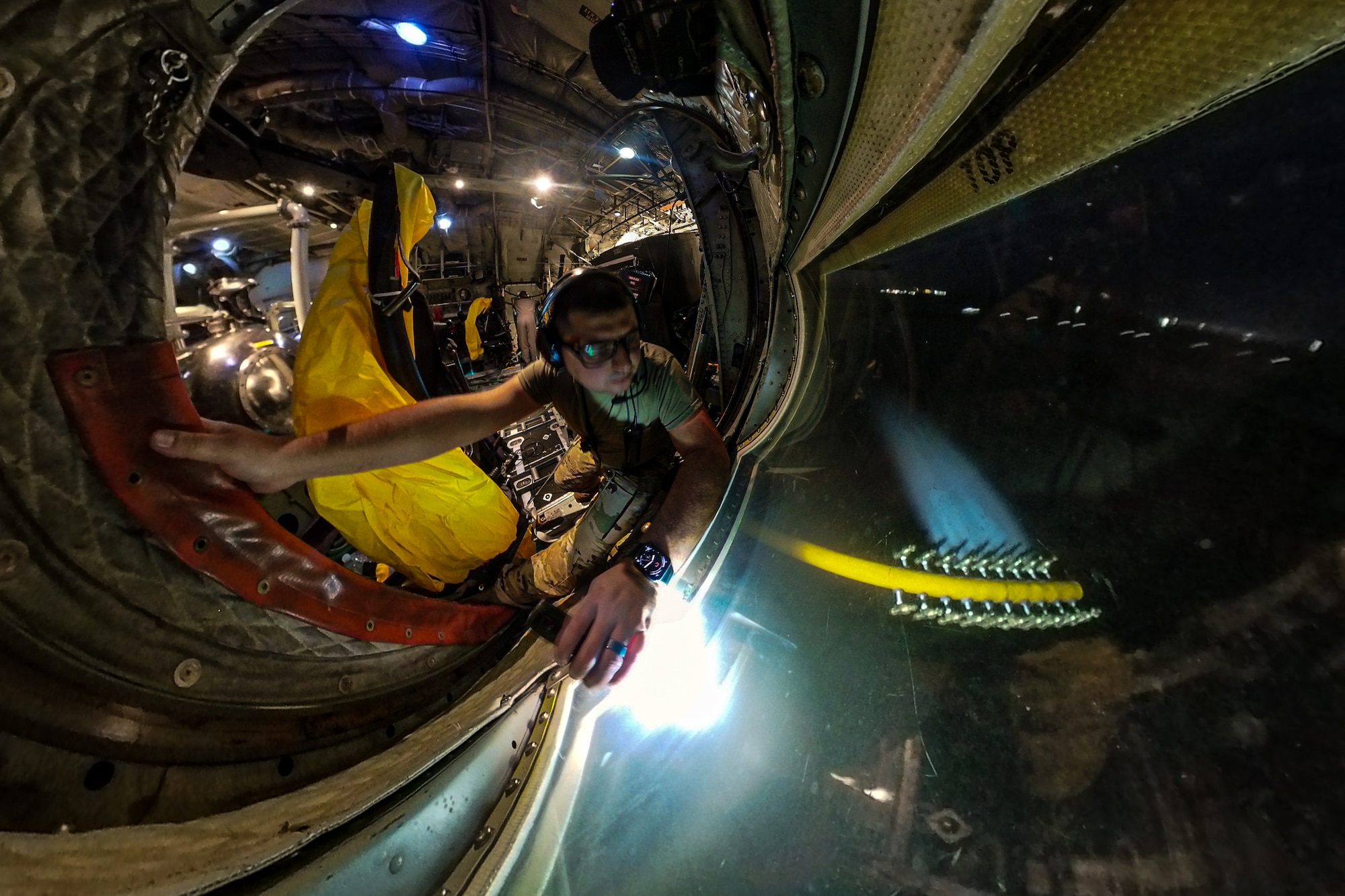 Senior Master Sgt. Andrew Marshall, an aerial spray qualified loadmaster assigned to the 757th Airlift Squadron, verifies product flow from within a 910th Airlift Wing aerial spray-modified C-130H Hercules aircraft dispersing mosquito control product, Sept. 9, 2025, over the marsh areas of the Naval Weapons Station, Joint Base Charleston, South Carolina.
