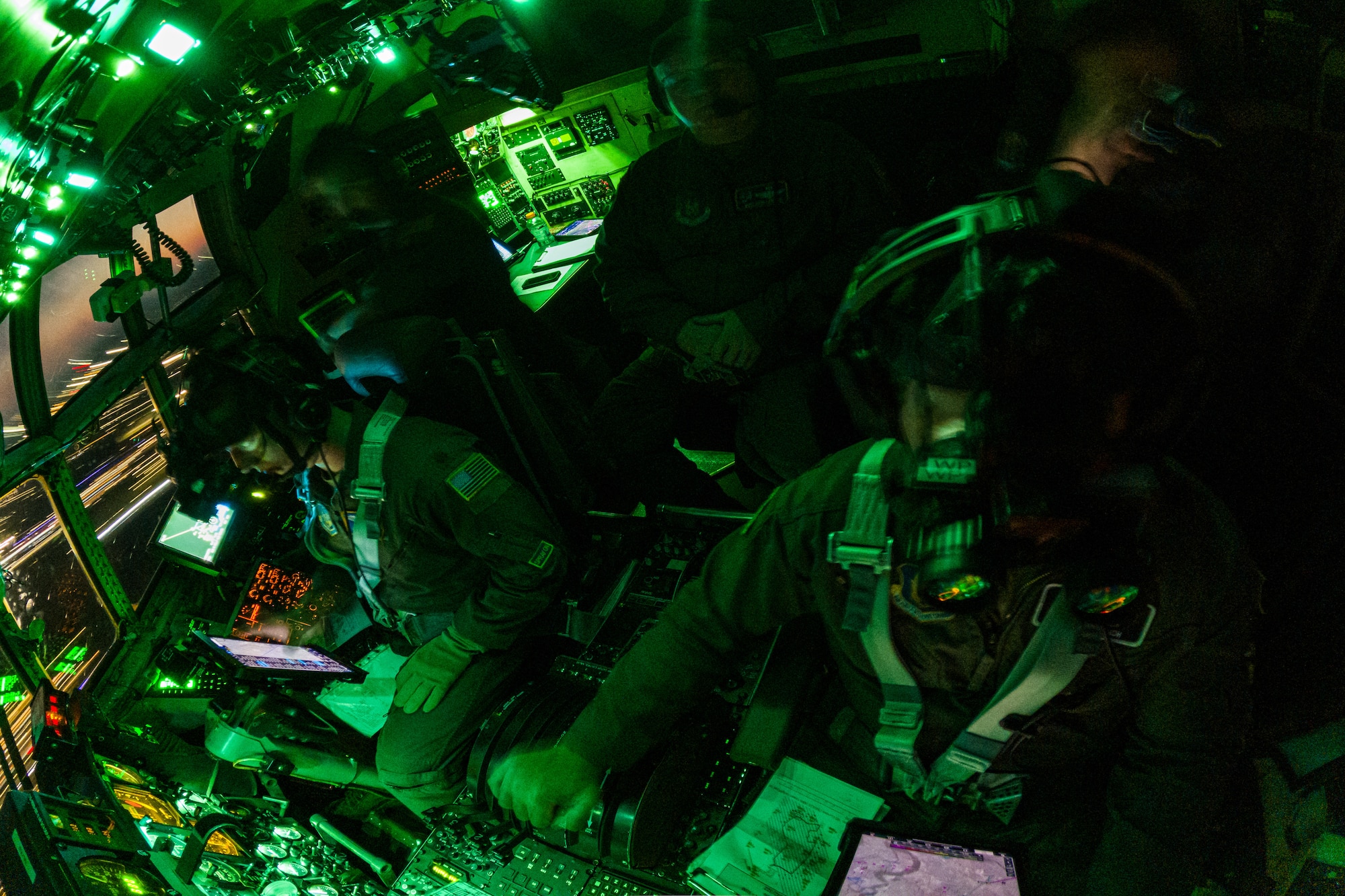 A Blue Tigers flight crew assigned to the 757th Airlift Squadron flies a 910th Airlift Wing aerial spray-modified C-130H Hercules aircraft at 300 feet using night vision goggles, Sept. 9, 2025, during an aerial spray mission combating the mosquito population in the marsh areas of the Naval Weapons Station, Joint Base Charleston, South Carolina.
