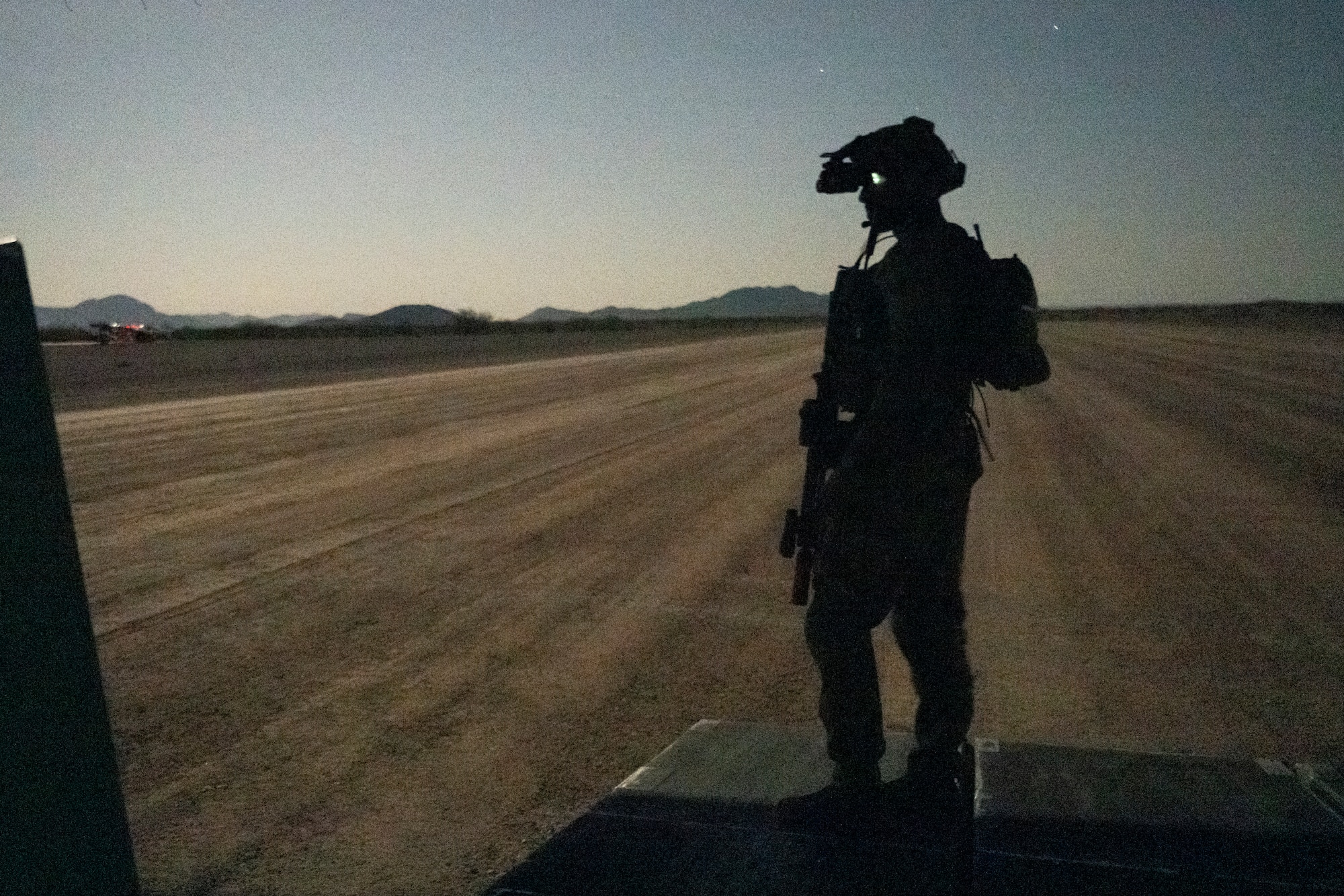 A U.S. Air Force Air Commando assigned to Air Force Special Operations Command stands watch on the ramp of a U.S. Air Force MC-130J Commando II in California during Emerald Warrior 25.2, Aug 7, 2025.