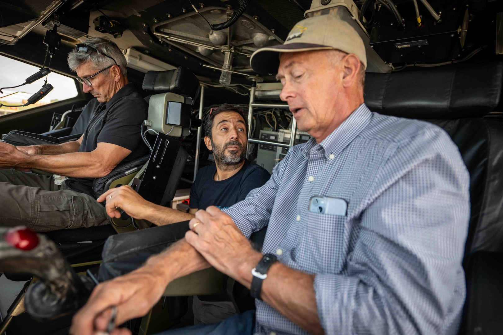 From left, Captain Al Frontin, Amitai Peleg, SEALARTEC CEO, and Dennis Danko, Stiletto Program Manager, discuss logistics of an autonomous boat launch and recovery demonstration in the pilothouse Stiletto in Norfolk, Virginia, on June 2, 2025.