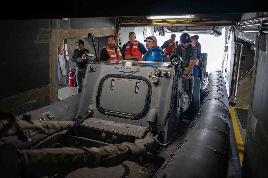 Carderock's Stiletto team talks the U.S. Coast Guard aboard a rigid-hull inflatable boat (RHIB) prior to an autonomous boat launch and recovery demonstration in Norfolk, Virginia, on June 2, 2025.