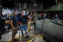 Cory Sears, Stiletto Chief Engineer, left, talks with Dennis Danko, Stiletto Program Manager, right, during an autonomous boat launch and recovery in Norfolk, Virginia, on June 2, 2025.