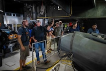 Cory Sears, Stiletto Chief Engineer, left, talks with Dennis Danko, Stiletto Program Manager, right, during an autonomous boat launch and recovery in Norfolk, Virginia, on June 2, 2025.