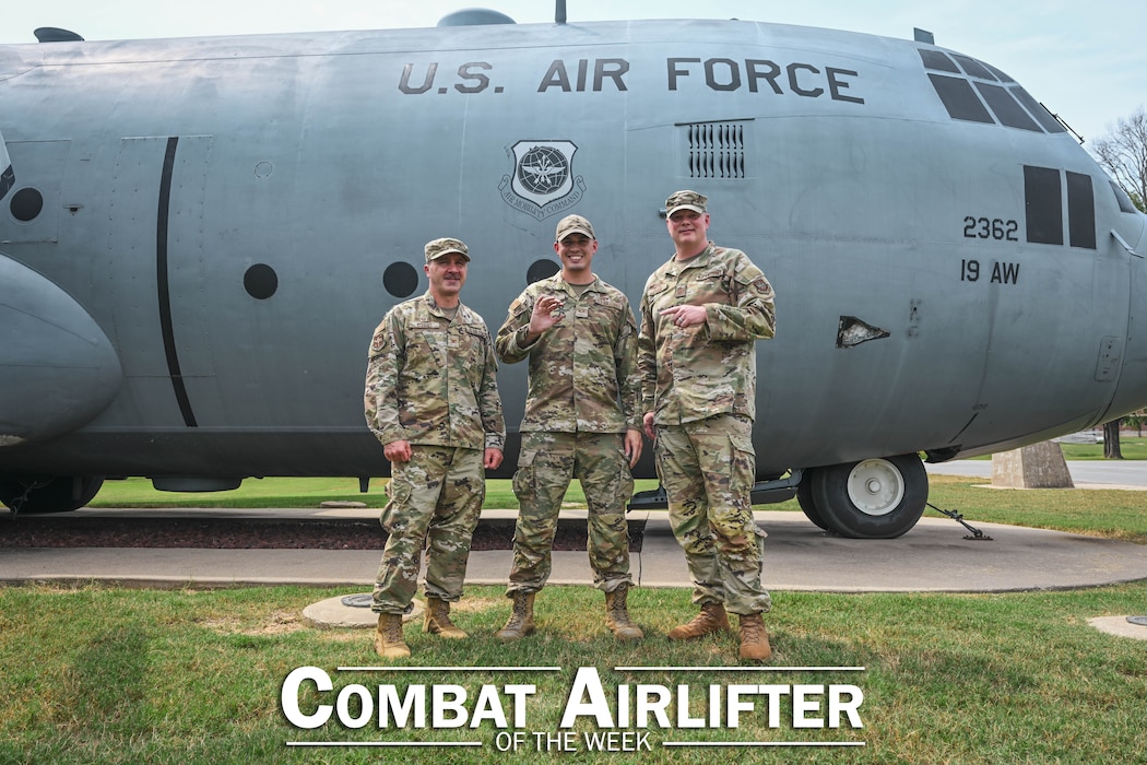 Three people pose in front of a plane.
