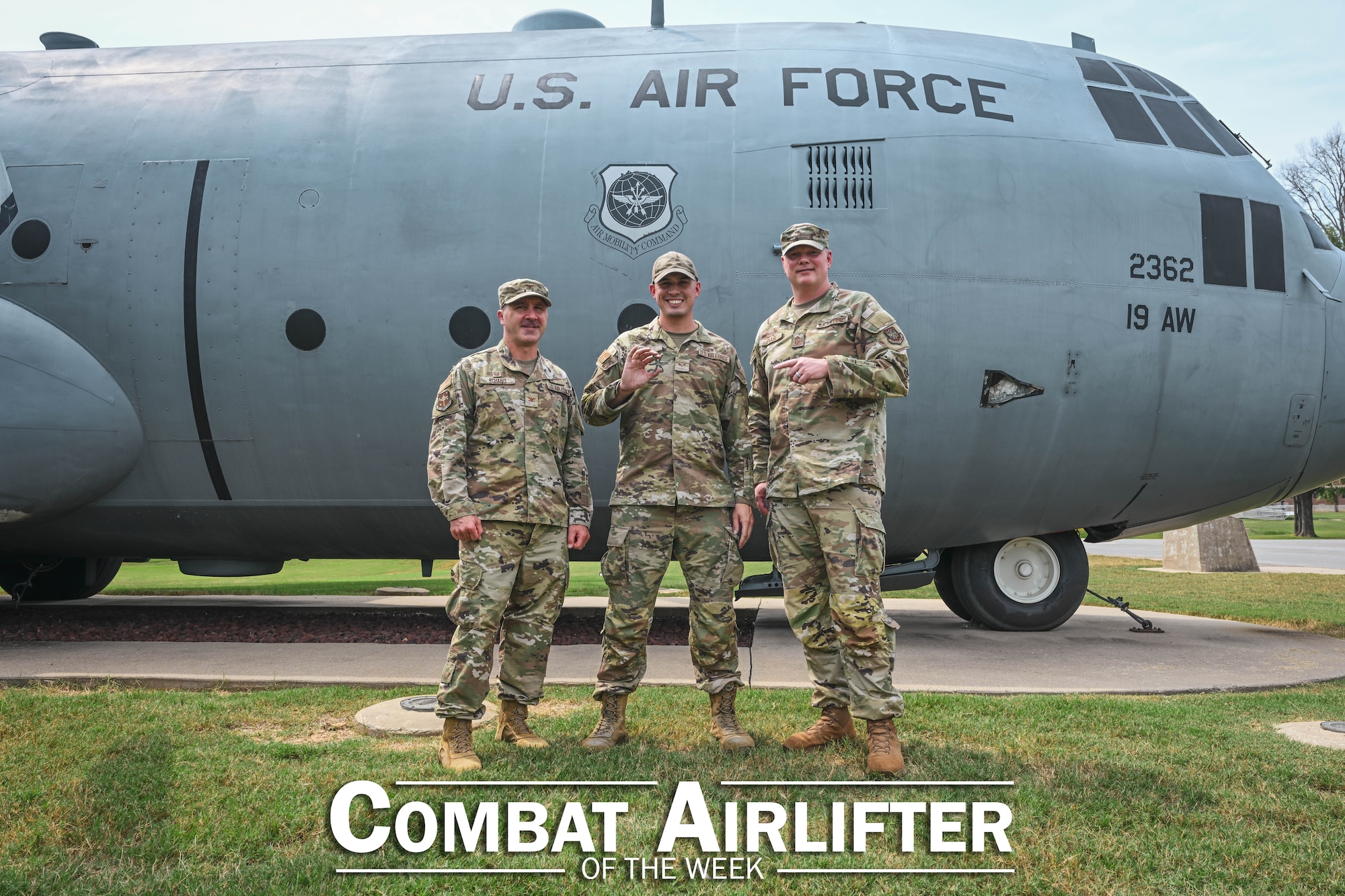 Three people pose in front of a plane.