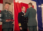 Adm. Stuart B. Munsch, commander, U.S. Naval Forces Europe-Africa, center, receives the Norwegian Defence Service Medal from Gen. Eirik Kristoffersen, Norwegian Chief of Defence aboard the world’s largest aircraft carrier USS Gerald R. Ford (CVN 78), during its scheduled port call to Oslo, Norway, Sept. 13, 2025.
