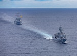 Arleigh Burke-class guided-missile destroyer USS Dewey (DDG 105), left, sails alongside Anzac-class frigate HMAS Ballarat (FFH 155), right, during a bilateral training with the Royal Australian Navy in the South China Sea, Sept. 16, 2025.