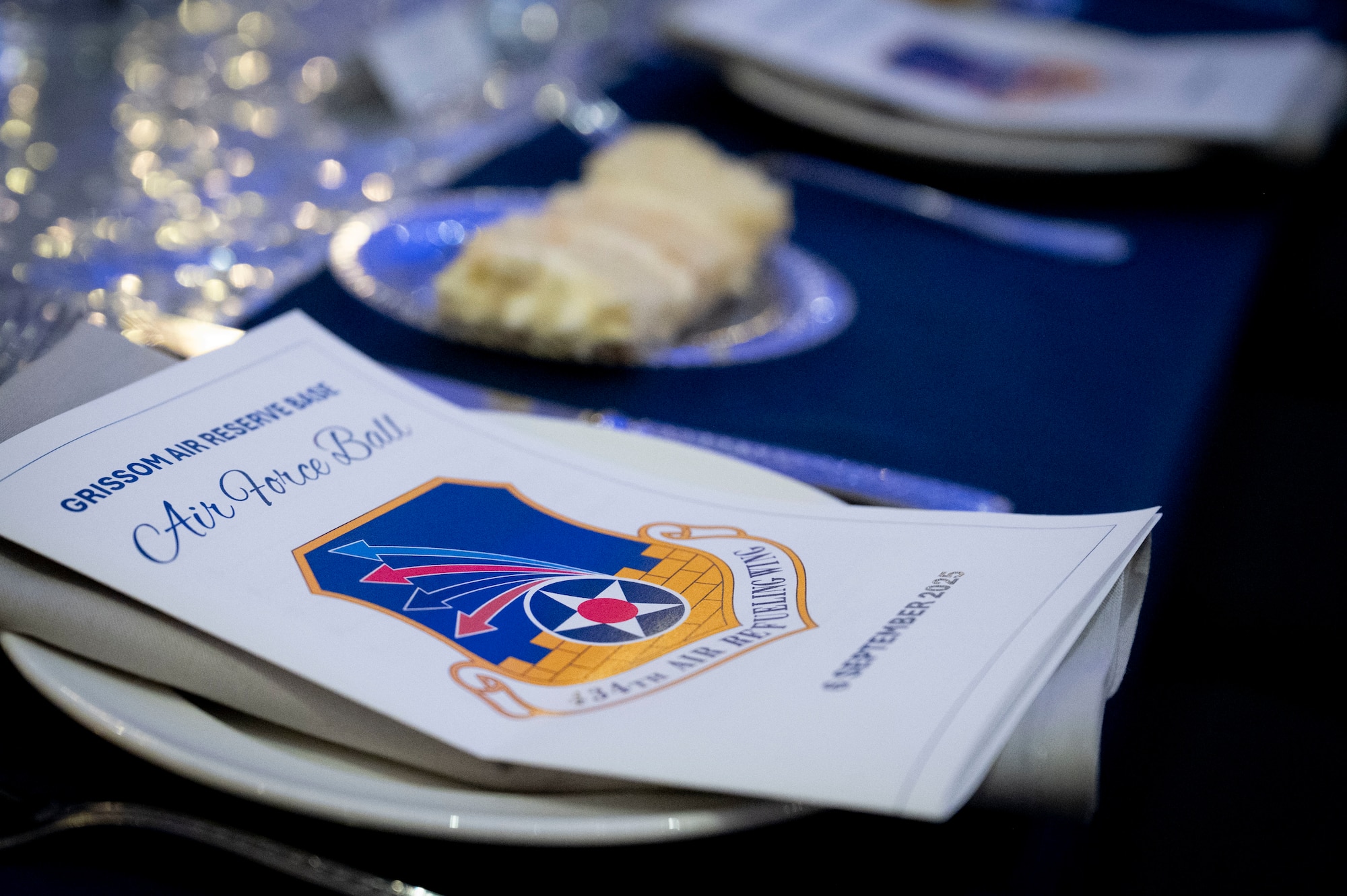 An event program and a slice of cake lay on a place setting during the Air Force Ball hosted by the 434th Air Refueling Wing