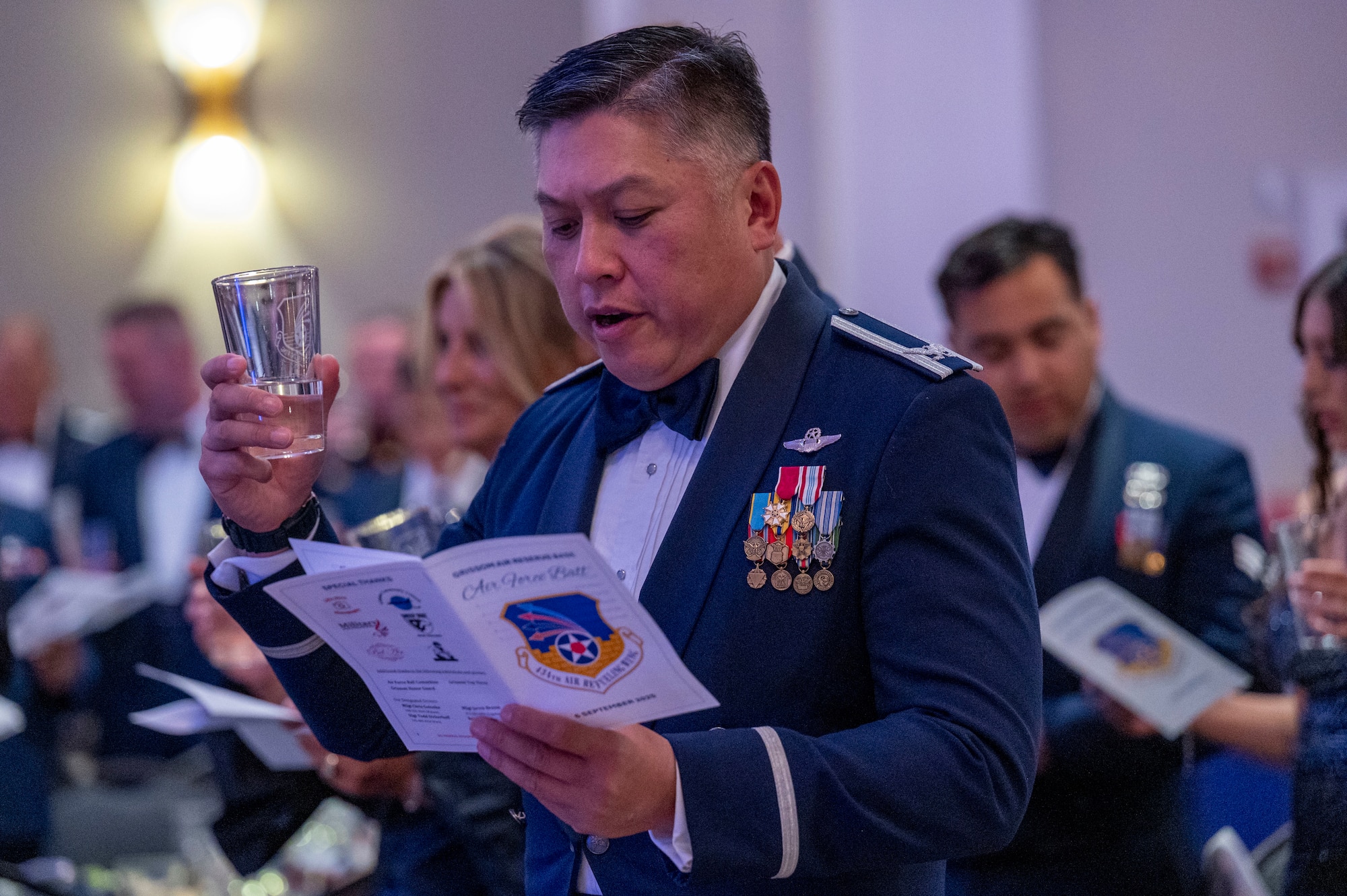 Former commander of the 434th Air Refueling Wing raises his glass during the toasting ceremony