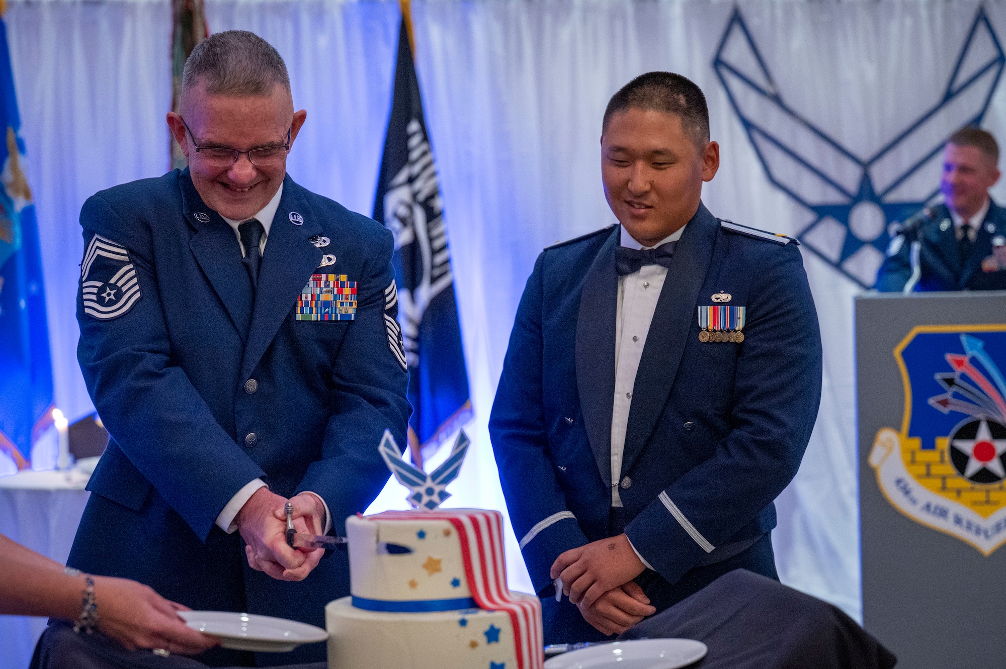 434th Mission Support Group senior enlisted leader, uses the Air Force saber to cut the first piece of cake during the cake cutting ceremony