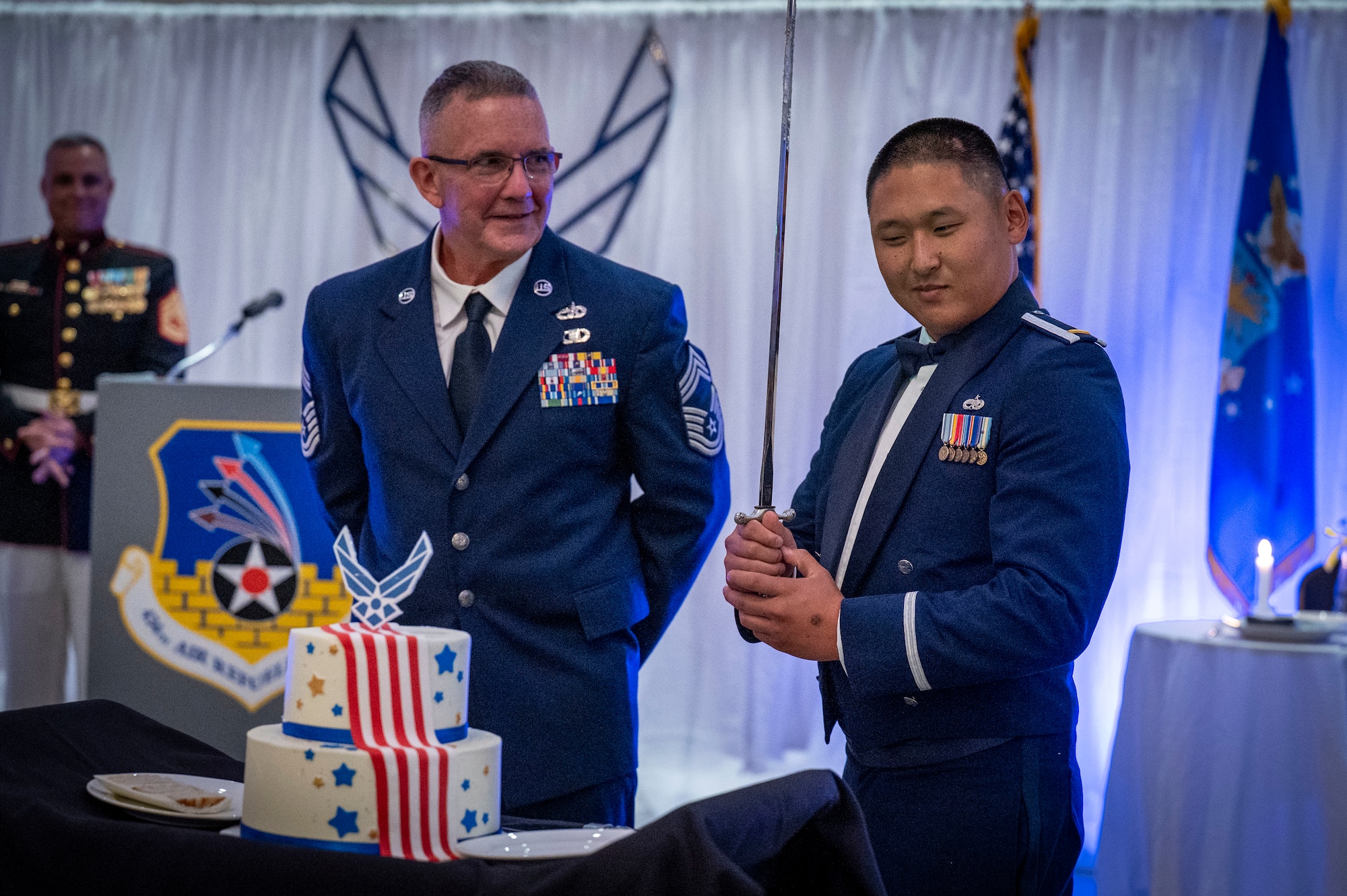 Maintenance Squadron flight commander, cuts the second piece of cake during the cake cutting ceremony