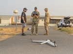 Peter DeJoseph, left, a Red Cat flight trainer, observes as Staff Sgt. First Class Gregory Mannen, center, and Staff Sgt. Timothy Powers operate the Flightwave Edge 130 unmanned aircraft system during training at the 249th Regional Training Institute, Rees Training Center, Oregon, Sept. 4, 2025. The Edge 130 provides vertical takeoff and landing capabilities with transition to fixed-wing flight, offering up to 90 minutes of flight time and advanced intelligence, surveillance, and reconnaissance capabilities for Oregon Army National Guard units.