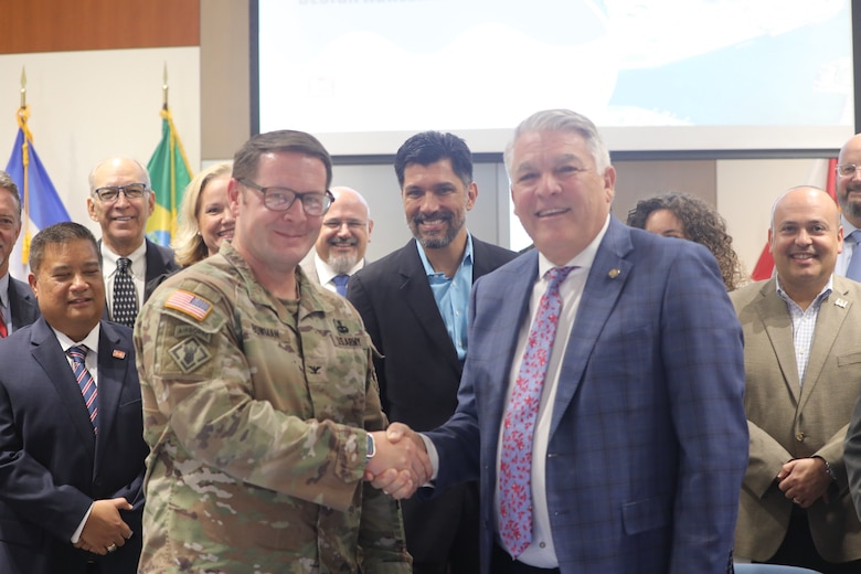 Col. Brandon Bowman, Commander, Jacksonville District and Mr. Paul Anderson, President and Chief Executive Officer of Port Tampa Bay shake hands after signing the Preconstruction Engineering and Design Agreement for the Tampa Harbor Federal Deep Draft Navigation Project during a ceremony this morning.