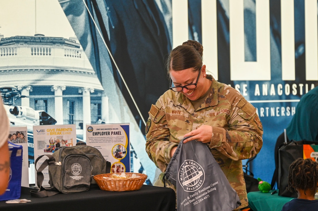 U.S. Air Force Master Sgt. Candice White, flight chief at the Military & Family Readiness Center, prepares a resource bag for guests attending the Health and Readiness Optimization Fair event at Joint Base Anacostia-Bolling, Washington, D.C., Sept. 12, 2025. This event introduced participants with 23 helping agencies that provided health and resilience resources. (U.S. Air Force photo by Airman 1st Class Shanel Toussaint)