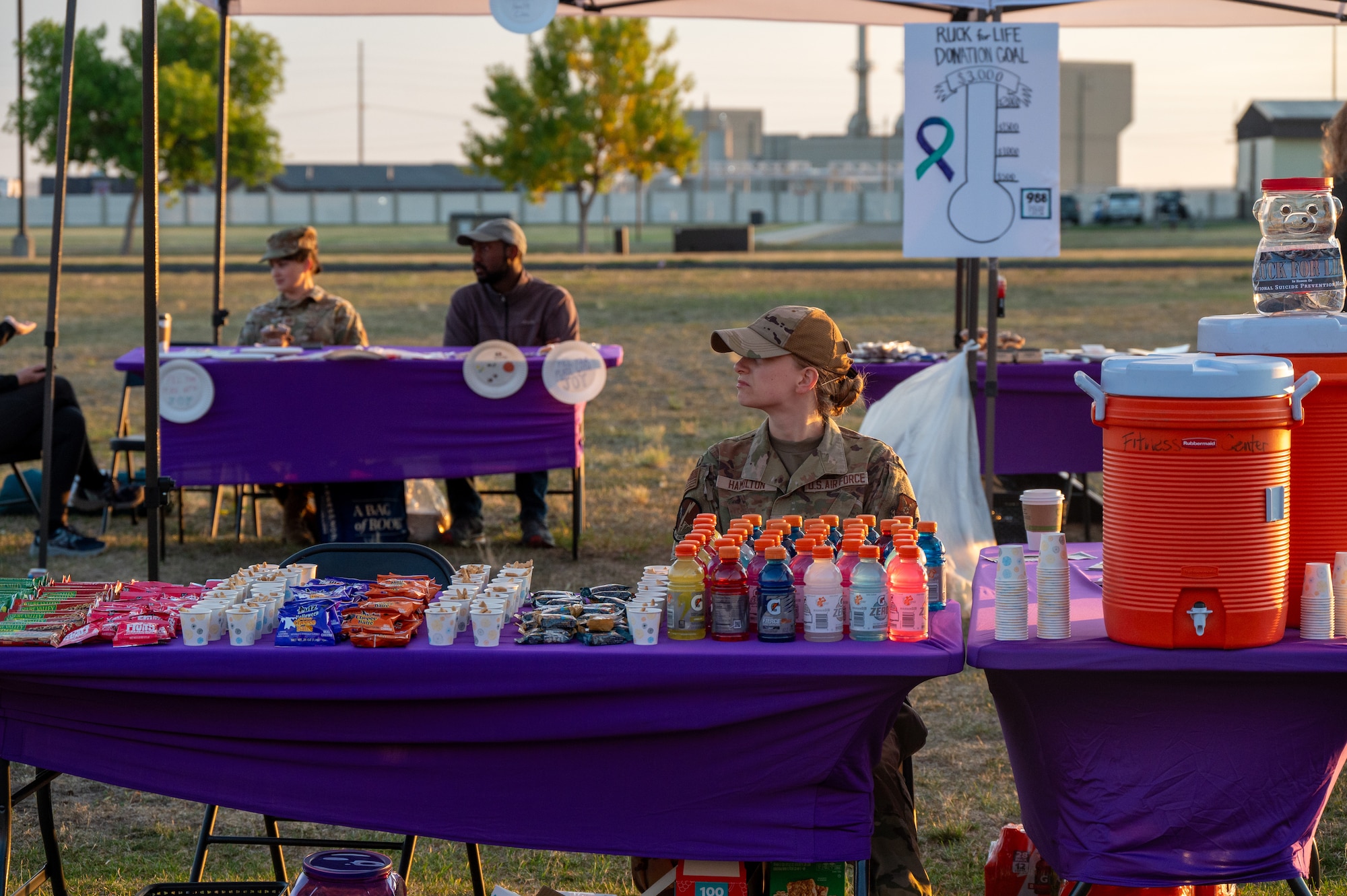 Uniformed personnel sits at a refreshment table