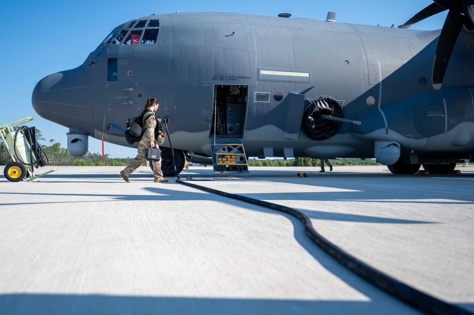 An Airman walking up to the entrance of an AC-130J