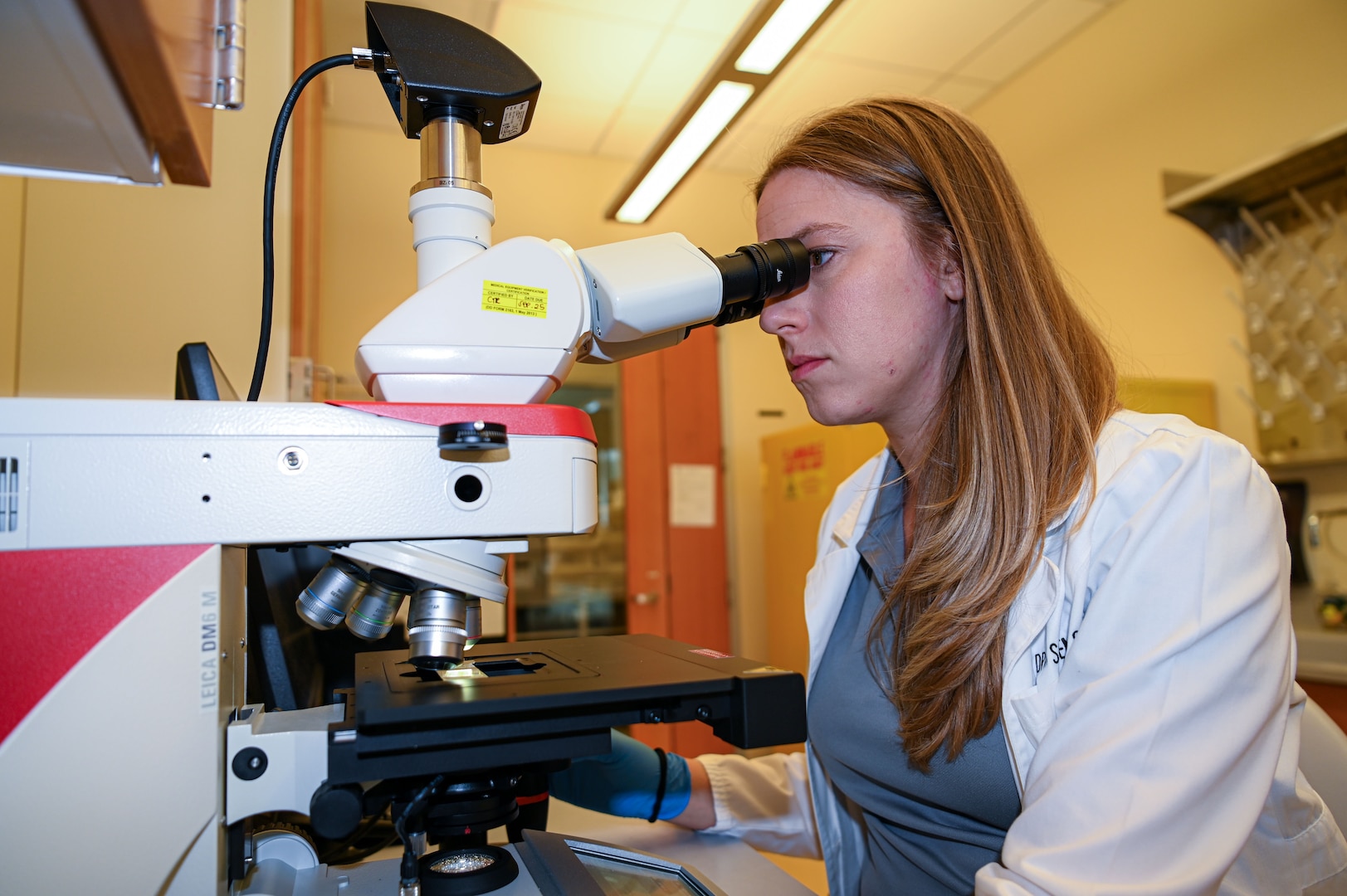 Kristin Bukovec, a DPAA laboratory quality manager, function checks a lab microscope at the Daniel K. Inouye DPAA Center of Excellence, Joint Base Pearl Harbor-Hickam, Sept. 2, 2025.