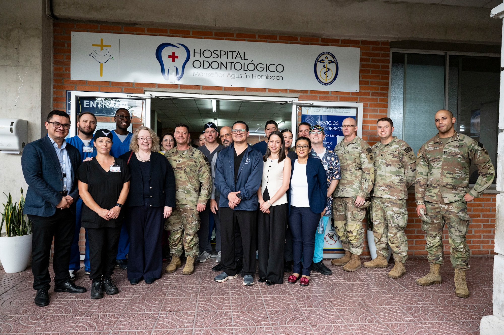 U.S. Embassy Charge d’Affaires Colleen Hoey, service members from Joint Task Force-Bravo stationed at Soto Cano Air Base, Honduras; members from the 302nd Airlift Wing, Peterson Space Force Base, Colorado; Honduran medical professionals; pose for a group photo after JTF-Bravo's two-week community dental event at Universidad Catolica, Honduras, Aug. 27, 2025.  Global Health Engagements help cultivate common bonds and foster goodwill between the U.S. and regional nations by providing humanitarian assistance which improves the well-being of the community. (U.S. Air Force photo by Staff Sgt. Sadie Colbert.)