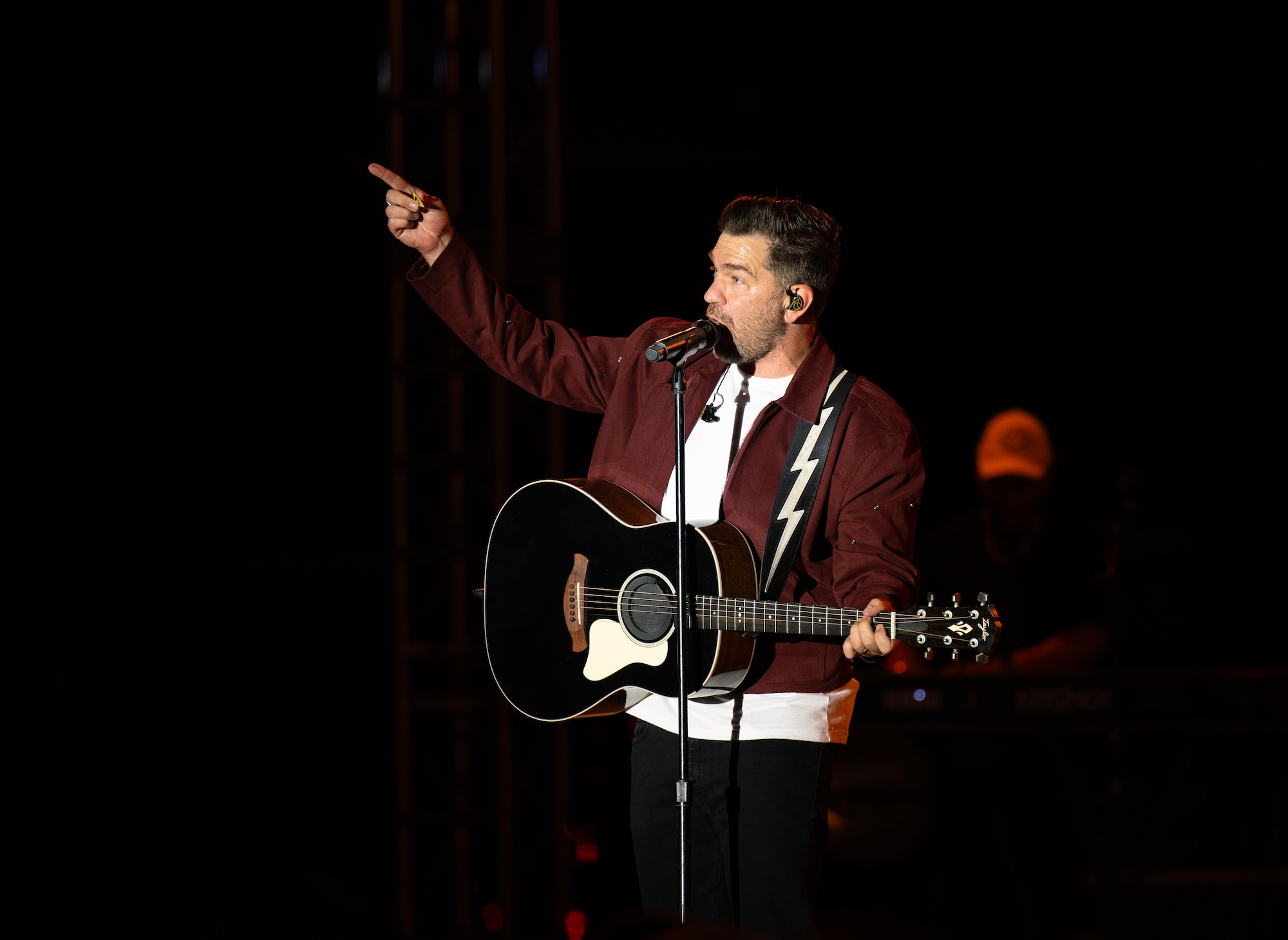 Andy Grammer points to the crowd while performing his hit songs at Laughlin Air Force Base, Texas, Sept. 12, 2025. The event brought the community together with music, food, and family activities. (U.S. Air Force photo by Airman 1st Class Harrison Sullivan)