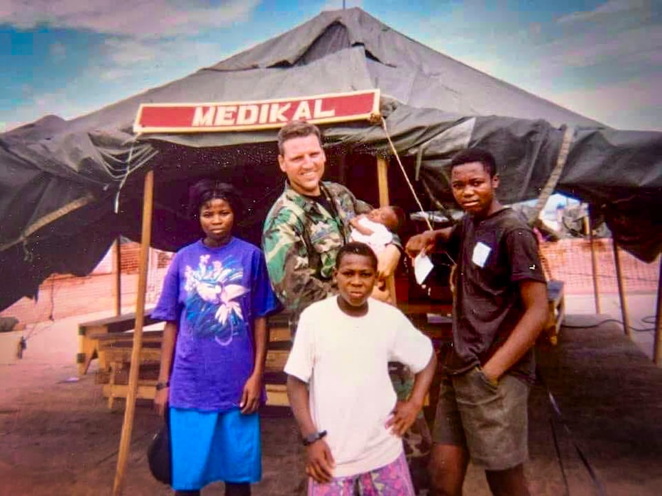 Retired U.S. Air Force Capt. Earl Morse, a physician assistant, provides medical care to Haitian orphans while deployed to Naval Station Guantanamo Bay, Cuba. (Courtesy photo from Morse)