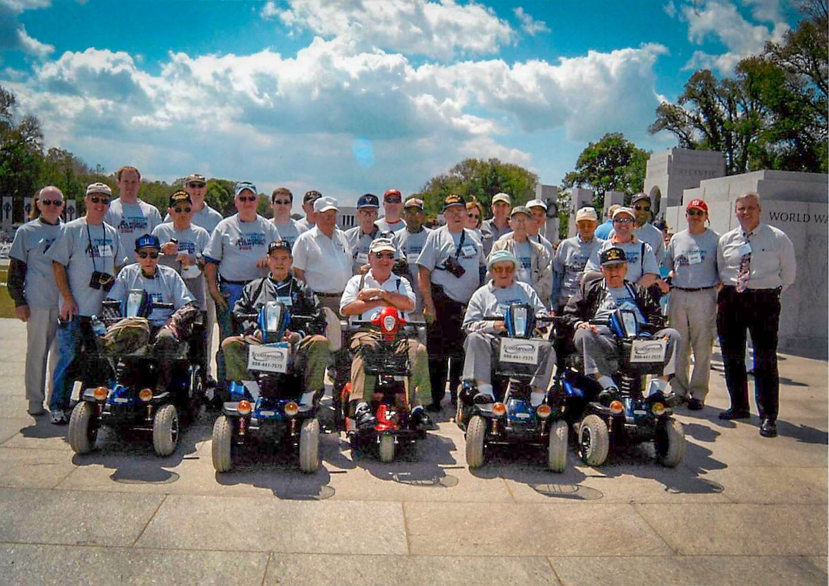 Retired U.S. Air Force Capt. Earl Morse, co-founder of Honor Flight, stands with World War II veterans and volunteer pilots at the National World War II Memorial in Washington, D.C., May 21, 2005. The photo shows the inaugural Honor Flight, composed solely of veterans and their pilots who served as guardians, marking the start of a nationwide movement to honor America’s aging heroes. (Courtesy photo from Morse)