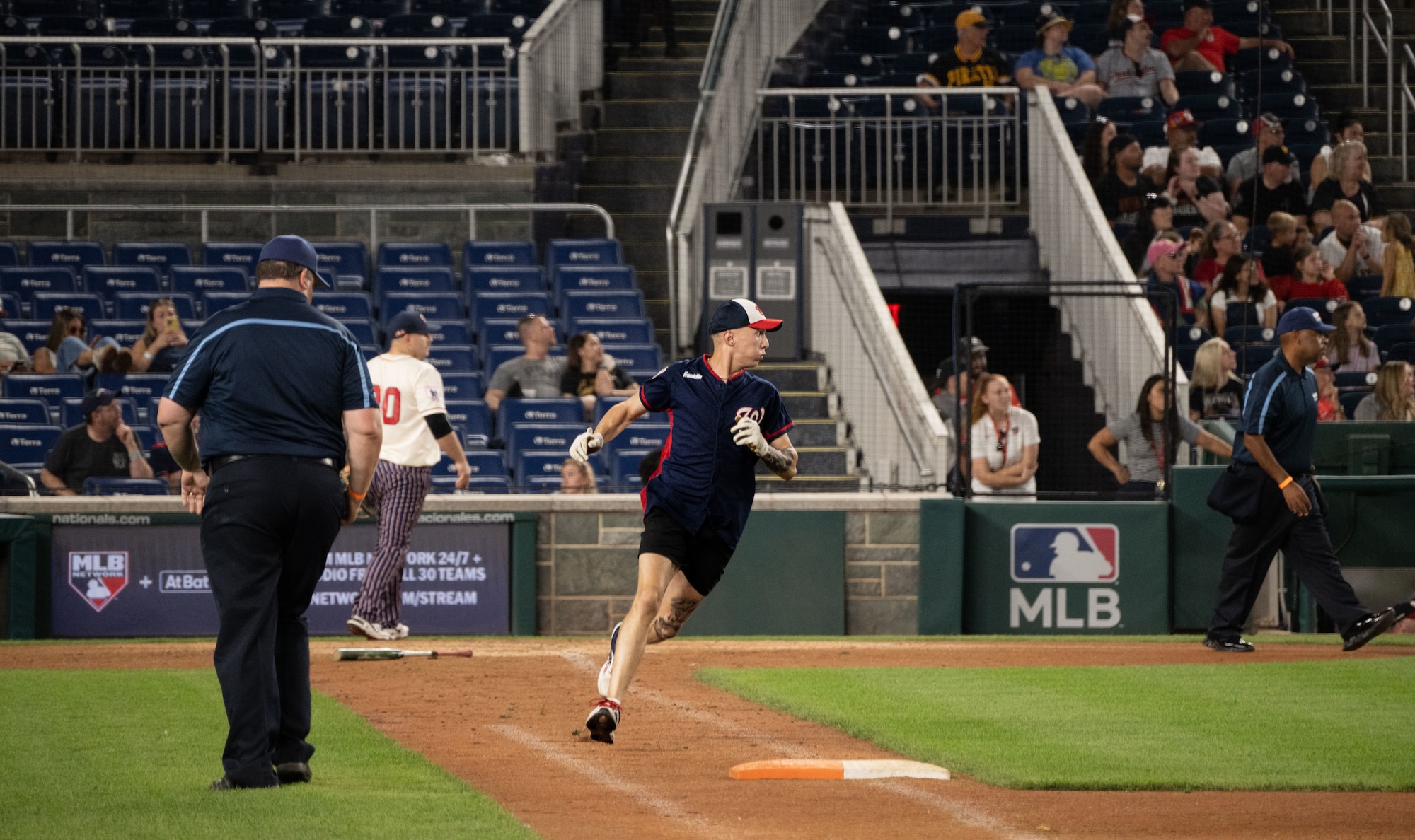 A member of the Marine Corps Base Quantico softball team rounds first base during the championship game of Battle of the Bases at Nationals Park, Washington, D.C., Sept. 13, 2025.