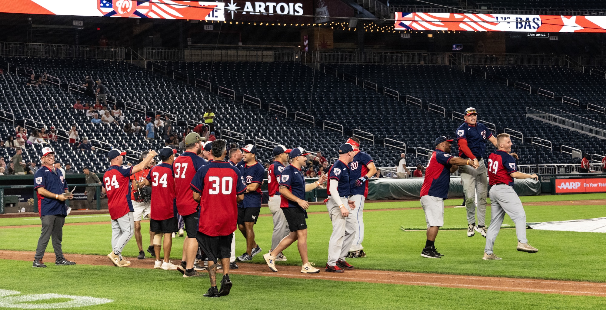 Members of the Marine Corps Base Quantico softball team celebrate after the championship game of Battle of the Bases at Nationals Park, Washington, D.C., Sept. 13, 2025.