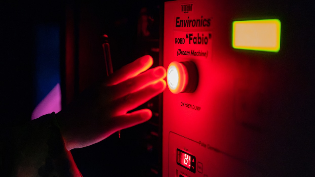 A hand is illuminated by a red light