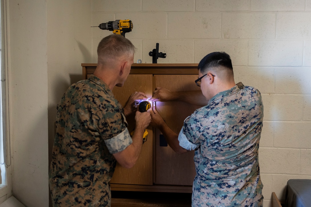 U.S. Marine Corps Lt. Gen. Christian F. Wortman, commanding general of I Marine Expeditionary Force, left, and Lance Cpl. Elijah Merino, a grenadier with 1st Marine Regiment, 1st Marine Division, repair a wall locker during Operation Clean Sweep III at Marine Corps Base Camp Pendleton, California, Sept. 16, 2025. OCS III, part of the ongoing Barracks 360 Reset initiative, demonstrates a collective commitment to improving living conditions through shared ownership, sustained accountability, and tangible improvements to the barracks. Wortman is a native of Pennsylvania and Merino is a native of California.  (U.S. Marine Corps photo by Sgt. Bryant Rodriguez)