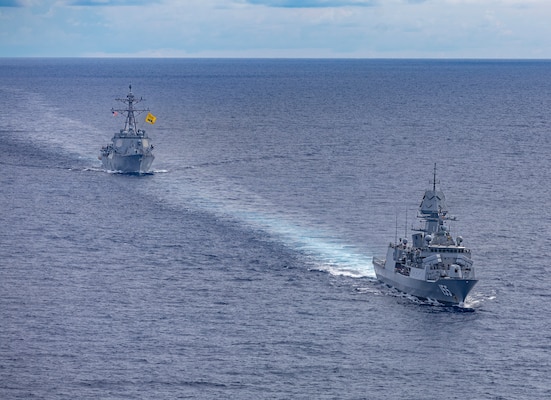 Arleigh Burke-class guided-missile destroyer USS Dewey (DDG 105), left, sails alongside Anzac-class frigate HMAS Ballarat (FFH 155), right, during a bilateral training with the Royal Australian Navy in the South China Sea, Sept. 16, 2025.