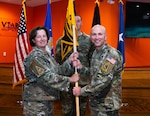 U.S. Space Force (USSF) Space Systems Command’s (SSC) stands up Systems Delta 81 (SYD 81) at Peterson Space Force Base, Colo. on Sept. 9, 2025. USAF Brig. Gen. Michelle Idle, mobilization assistant to the SSC commander, passes the SYD 81 guidon to USSF Col. Corey Klopstein, SYD 81 Commander. (USAF Photo by Senior Airman William Pugh)