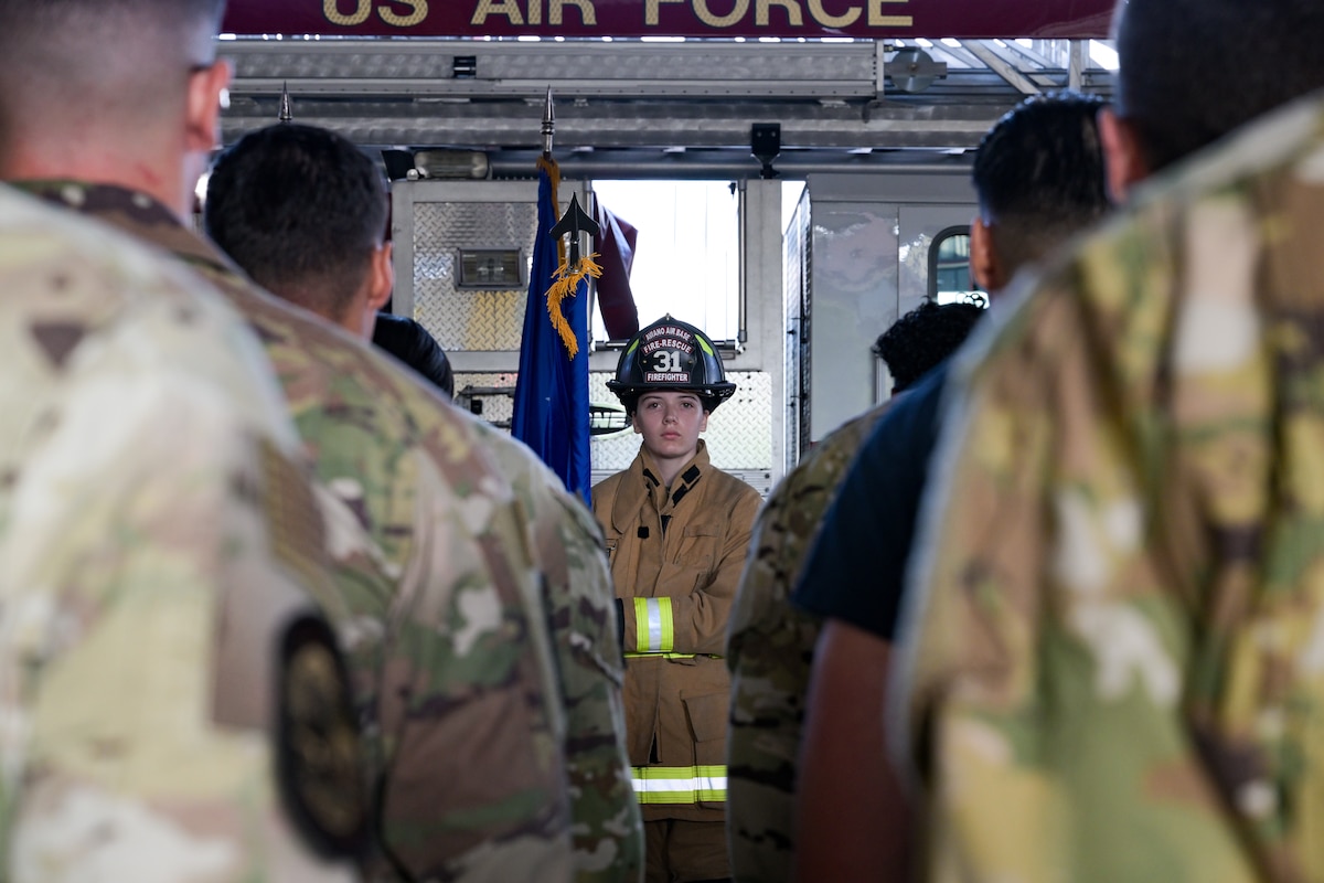 U.S. Air Force Senior Airman Emily Moran, 31st Civil Engineer Squadron firefighter, posts during the presentation of the colors at the 9/11 Ceremony held at the 31st CES fire department at Aviano Air Base, Italy, Sept. 11, 2025.