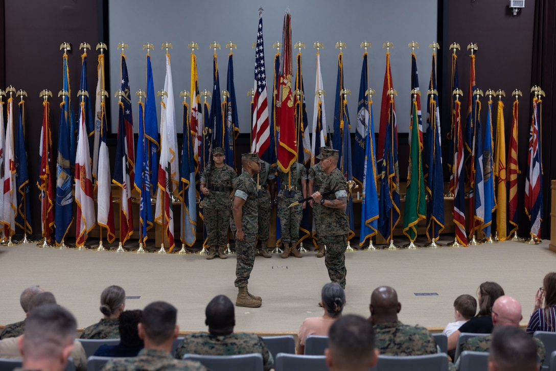 U.S. Marine Corps Lt. Gen. Calvert L. Worth Jr., commanding general, II Marine Expeditionary Force, left, and U.S. Navy Master Chief Petty Officer John C. Beck , command master chief, II MEF, stand at the position of attention during a change of charge ceremony at II MEF Headquarters Building, Marine Corps Base Camp Lejeune, North Carolina, Sept. 16, 2025.  The change of charge ceremony symbolized the transfer of responsibility and authority to ensure the well-being of all personnel under the charge of the command master chief. (U.S. Marine Corps photo by Lance Cpl. Caroline Perkins)