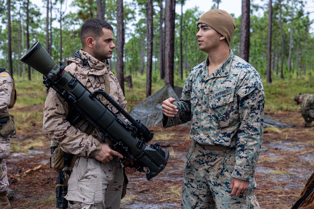U.S. Marine Corps Cpl. Phillip Garcia, an infantry rifleman with 2nd Battalion, 2nd Marines, (right) and Soldado Antonio Herrera with Infanteria de Marina (Spanish marines) (left) discuss the functions of an M3E1 Multi-purpose Anti-armor Anti-personnel Weapon System during Exercise UNITAS 25 at Camp Lejeune, North Carolina, Sept. 15, 2025. UNITAS, which is Latin for “unity,” was conceived in 1959 and has taken place annually since first conducted in 1960. This year marks the 66th iteration of the world’s longest running annual multinational maritime exercise. The exercise trains forces in joint maritime operations that enhance tactical proficiency and increase interoperability with the presence of unmanned air, surface and submarine systems. Garcia is a native of Texas. (U.S. Marine Corps photo by Sgt. Eduardo Delatorre)