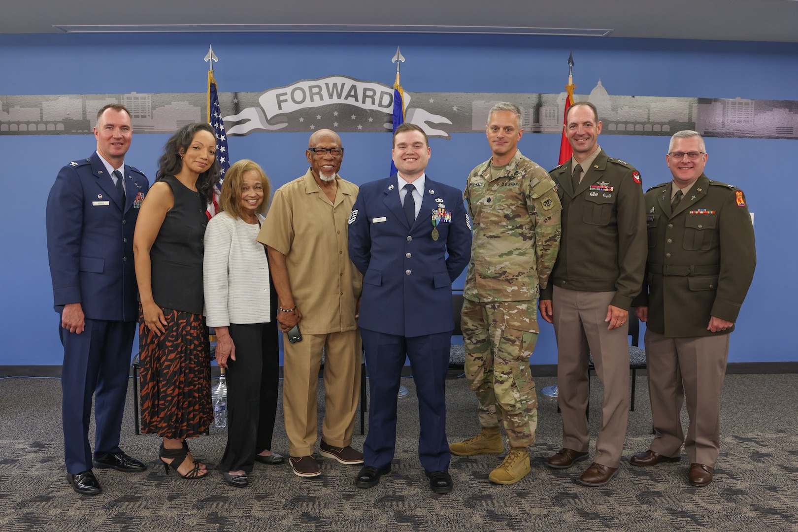 U.S. Air Force Tech. Sgt. Edward Wick, a munitions controller with the 115th Fighter Wing, Wisconsin Air National Guard, displays his new 1st. Lt. Thomas E. Wortham IV Award medal, alongside Wisconsin National Guard leadership and Wortham’s mother and sister. Wick received the award for excellence in his community and his military service through mentorship and commitment to others. (U.S. Air National Guard photo by Staff Sgt. Olivia Sherman)