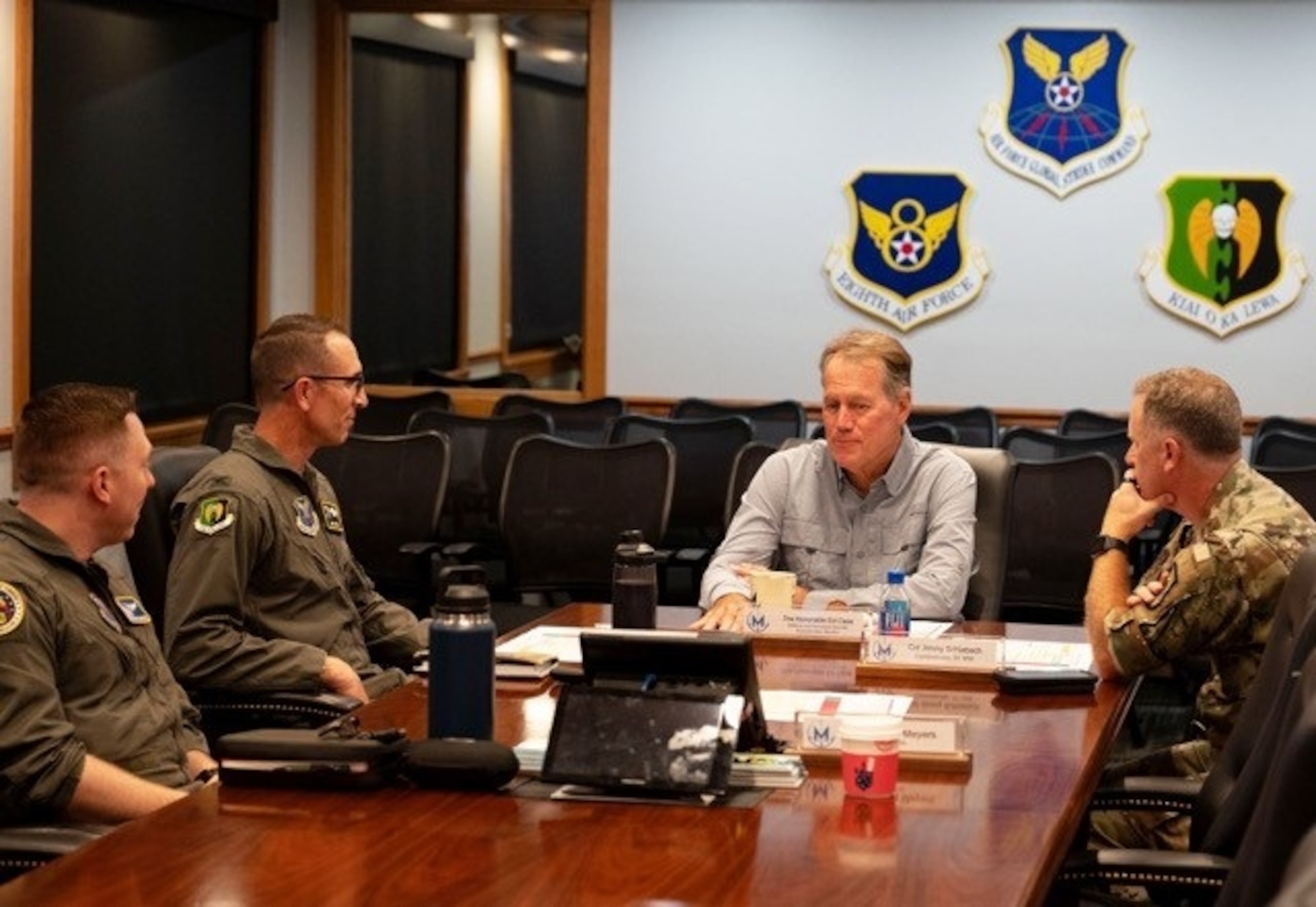 U.S. Air Force Lt. Col. Nicholas Conover, Detachment 12 site activation task force commander (far left), U.S. Air Force Col. Mike Taylor, 5th Bomb Wing deputy commander (center-left), and U.S. Air Force Col. James Schlabach, 91st Missile Wing commander (far right), provide a command mission brief to Rep. Ed Case, at Minot Air Force Base, North Dakota, Sept. 13, 2025. The brief covered how the base supports both the bomber and missile leg of the nuclear triad.