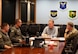 U.S. Air Force Lt. Col. Nicholas Conover, Detachment 12 site activation task force commander (far left), U.S. Air Force Col. Mike Taylor, 5th Bomb Wing deputy commander (center-left), and U.S. Air Force Col. James Schlabach, 91st Missile Wing commander (far right), provide a command mission brief to Rep. Ed Case, at Minot Air Force Base, North Dakota, Sept. 13, 2025. The brief covered how the base supports both the bomber and missile leg of the nuclear triad.