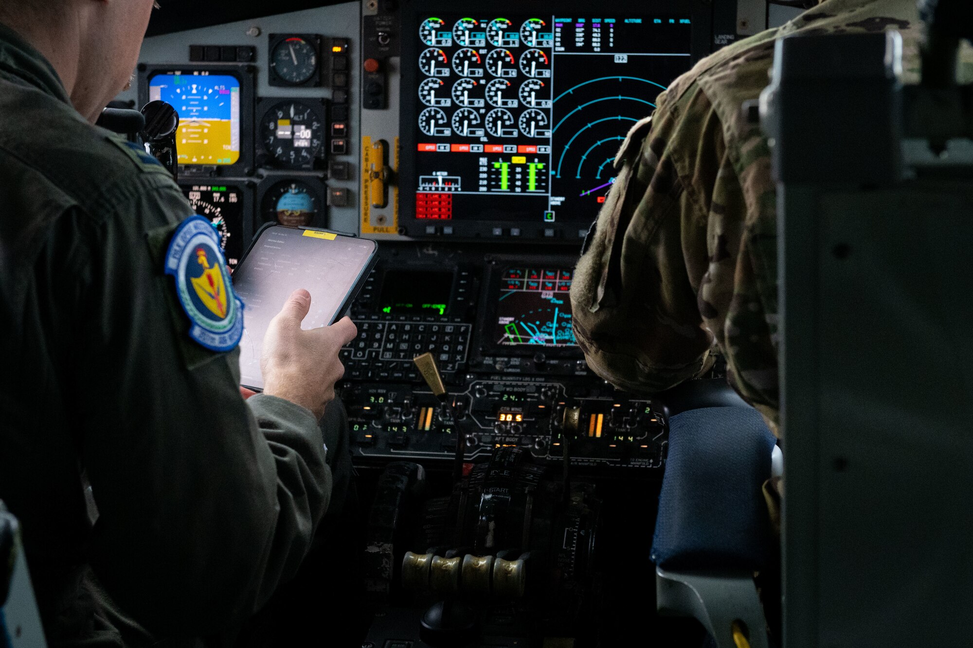 U.S. Air Force Captain Alexander Green (left), and Captain Edward Turos, 351st Air Readiness Squadron KC-135 Stratotanker pilot, read through a pre-flight checklist in preparation for takeoff during Cobra Warrior 25-2 at Royal Air Force Mildenhall, England, Sept. 16, 2024.