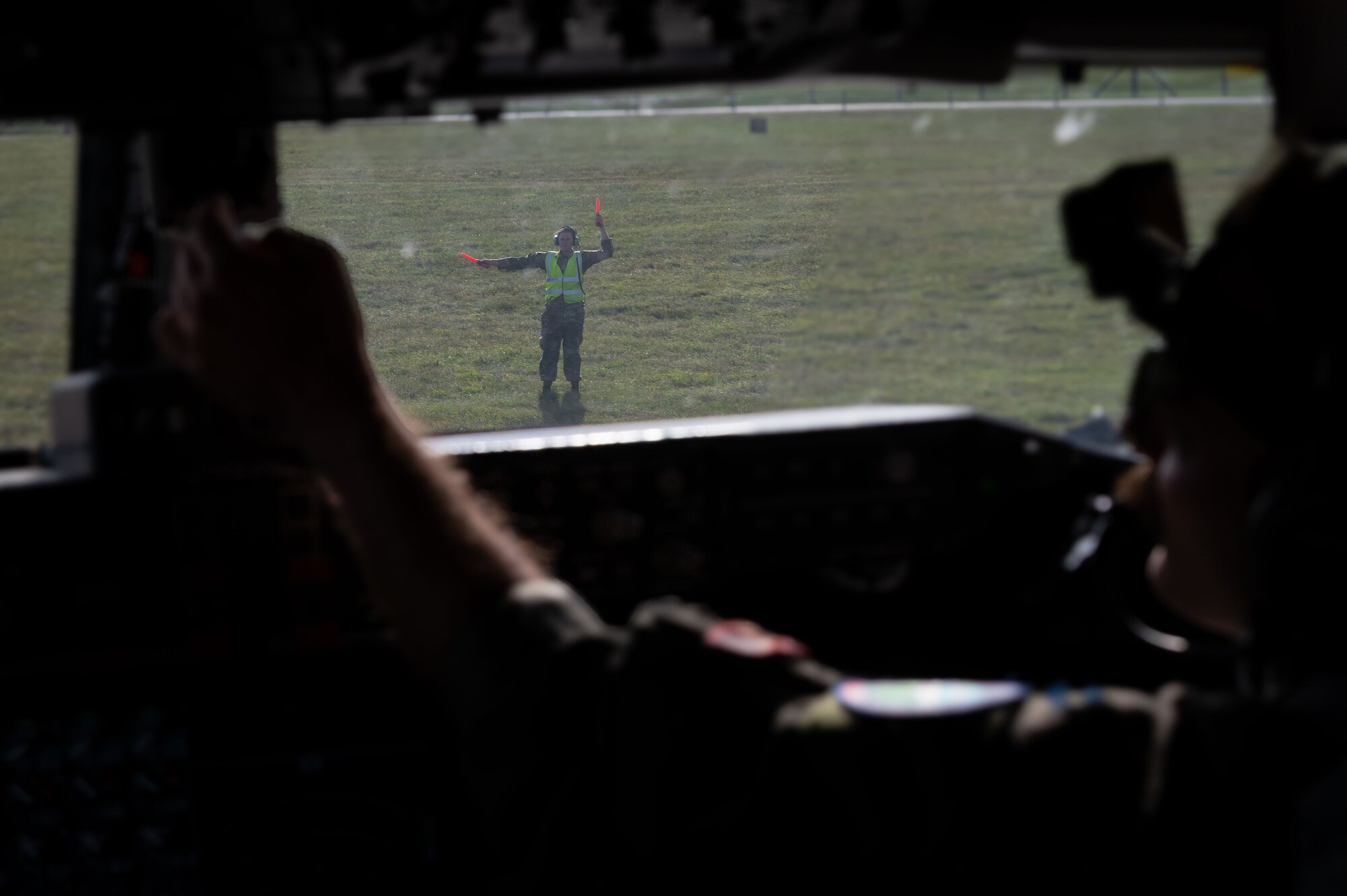 A U.S. Air Force Airman 1st Class Luke Vanderburgh, 100th Maintenance Squadron crew chief, marshals a KC-135 Stratotanker assigned to the 100th Air Refueling Wing to the flight line during exercise Cobra Warrior at RAF Mildenhall, Sept. 16, 2025.