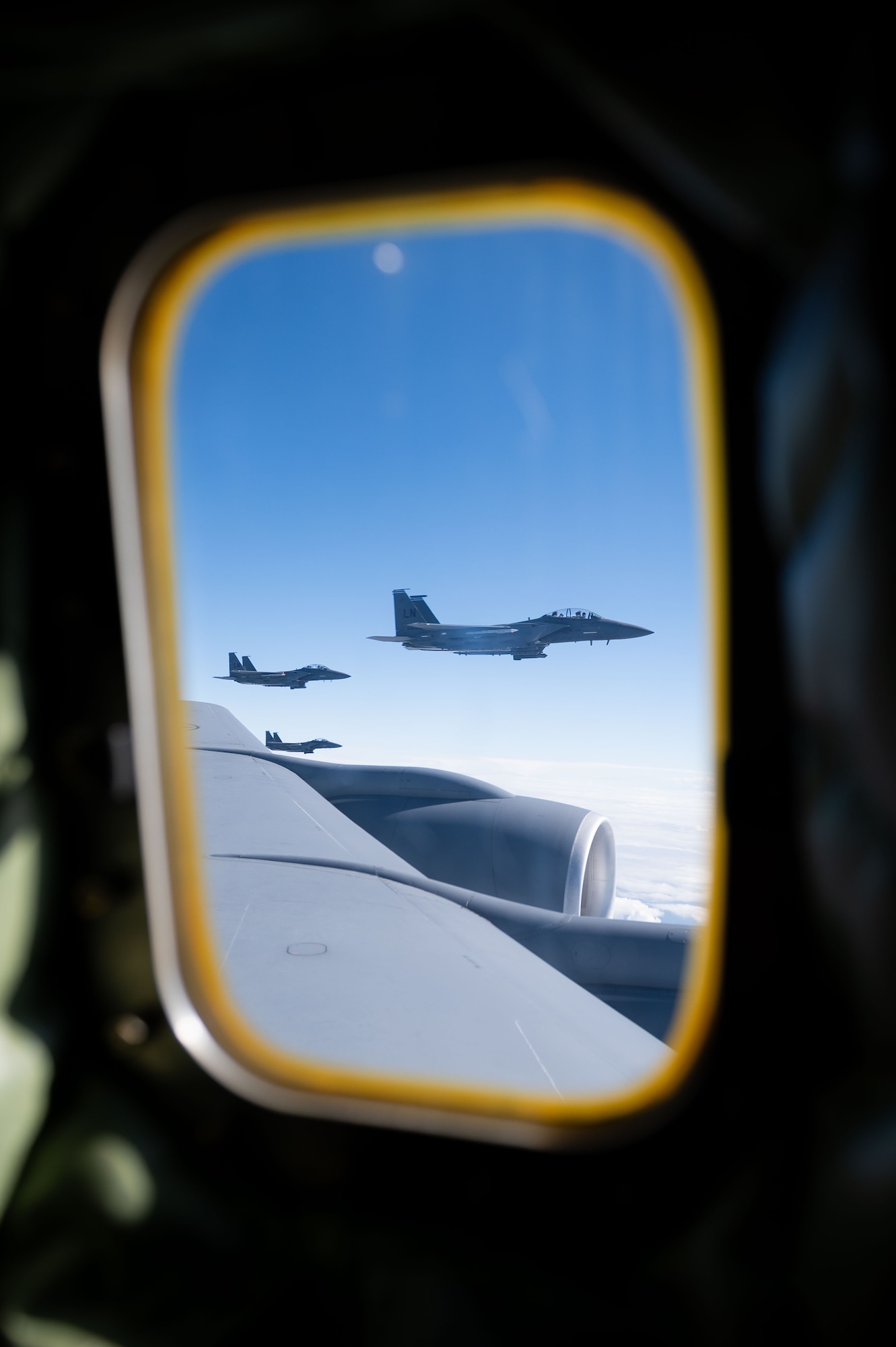 Three U.S. Air Force F-15E Strike Eagle from the 48th Fighter Wing at RAF Lakenheath, fly alongside a KC-135 Stratotanker from the 100th Air Refueling Wing after receiving fuel during exercise Cobra Warrior, over the North Sea, Sept. 16, 2025.