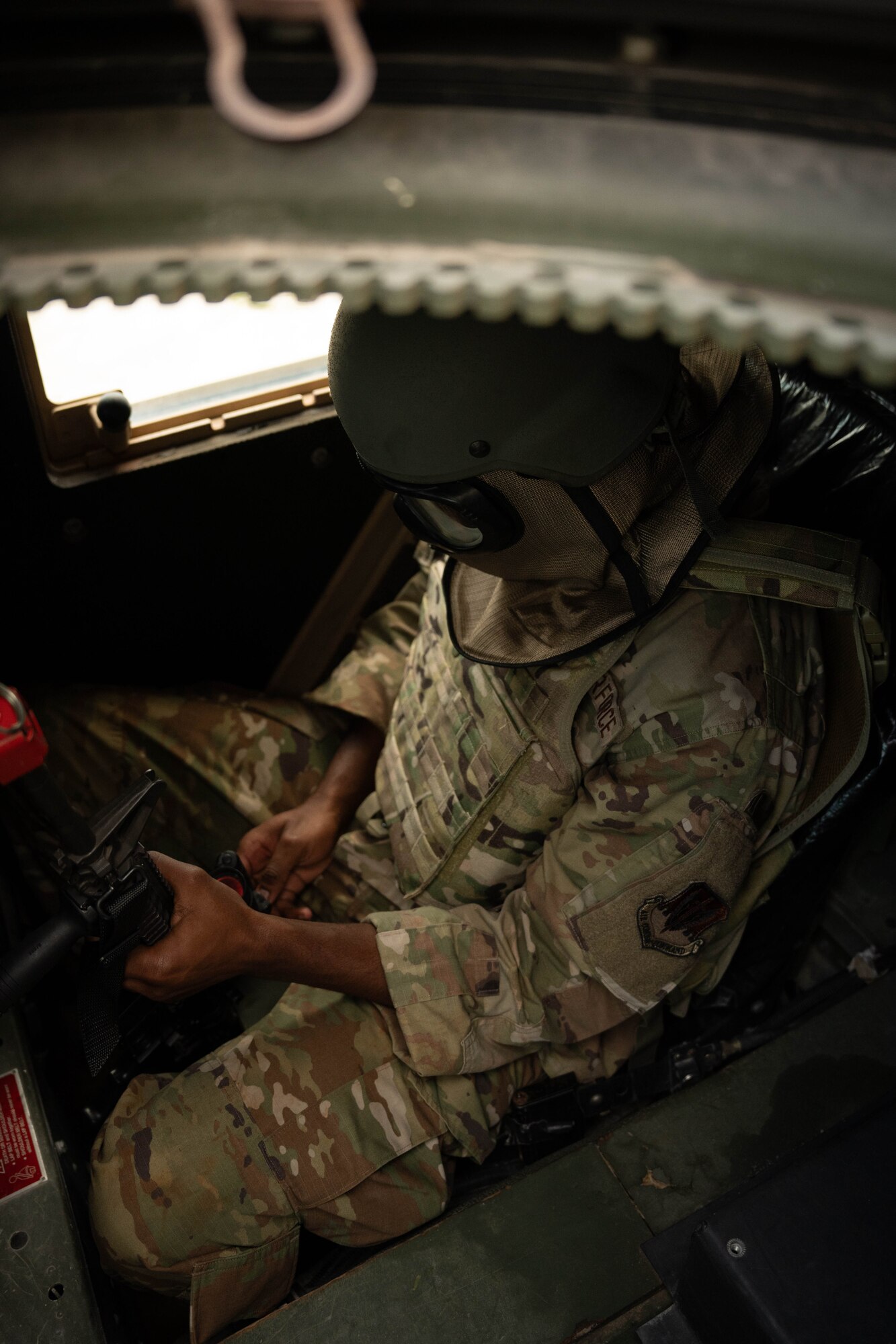 U.S. Air Force Airman 1st Class Bryant Robinson, 325th Communications Squadron cable and antenna systems technician, inspects an M4 rifle during exercise Ground-to-Air Transmit and Receive Aid.